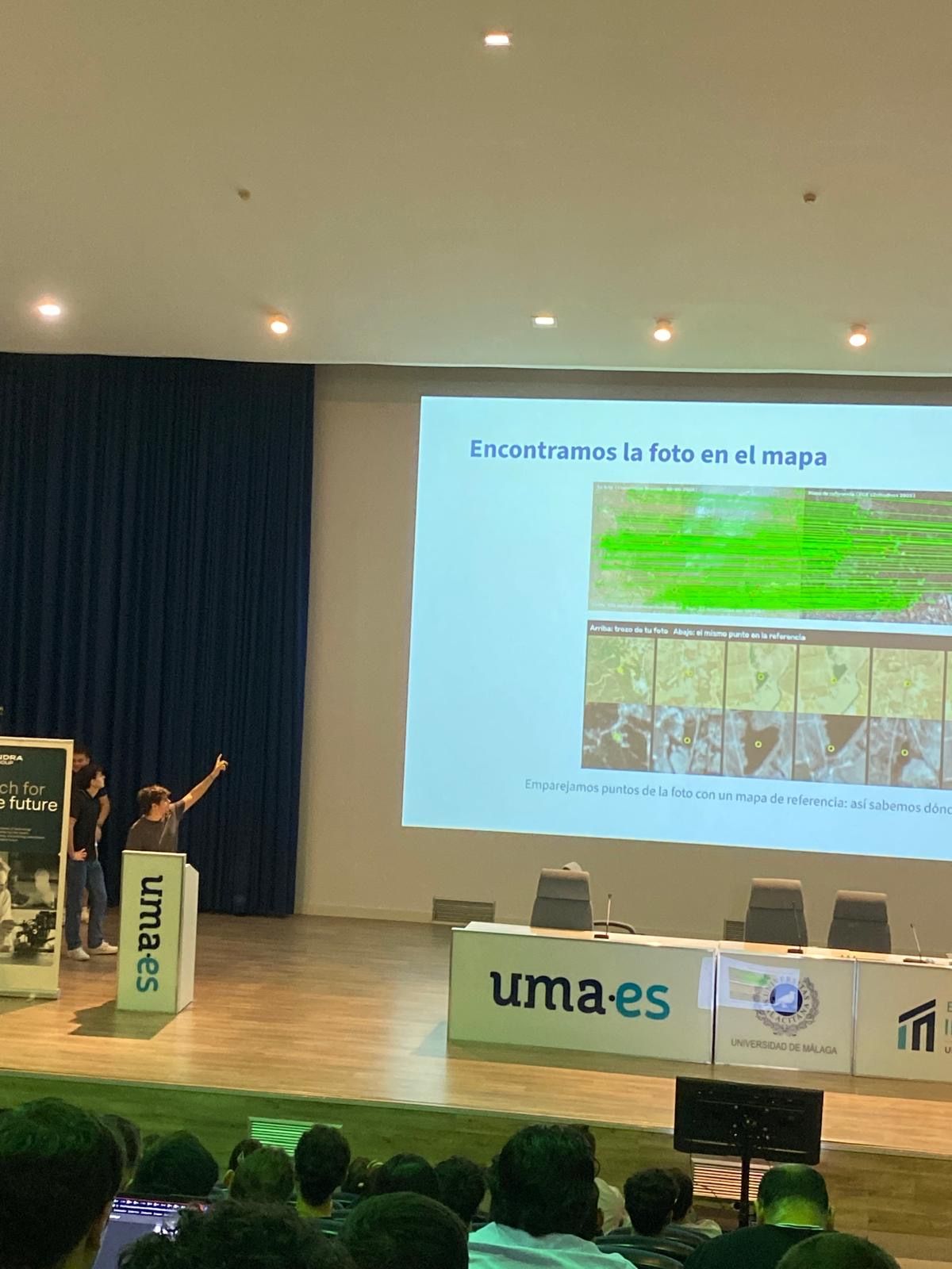 Cayetano on stage at Malakathon showing how the satellite image was matched to a reference map